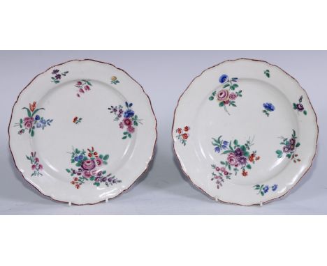 A pair of 18th century Worcester polychrome shaped circular plates decorated with bouquets of flowers in the Meissen style, i