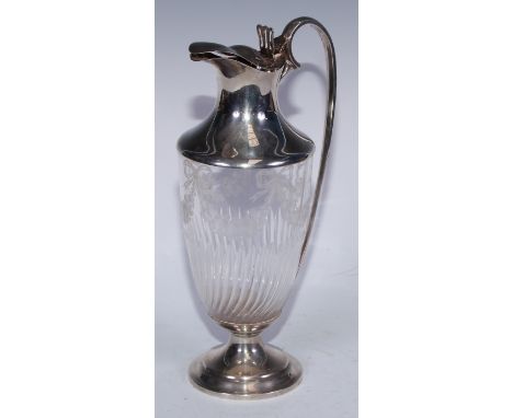 A Victorian Neo-Classical Revival silver mounted vase shaped claret jug, etched and cut with ribbon-tied swags above a fluted