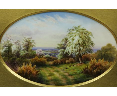 A Royal Worcester oval plaque painted by Raymond Rushton, signed, with rabbits grazing in blooming spring meadows, printed ma
