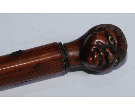 An 18th century novelty walking stick, of slavery and slave trade period, the pommel carved as the head of an African America