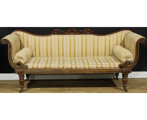 A Regency rosewood scroll end sofa, shaped cresting carved with an anthemion, flowerheads and leafy scrolls, stuffed over uph