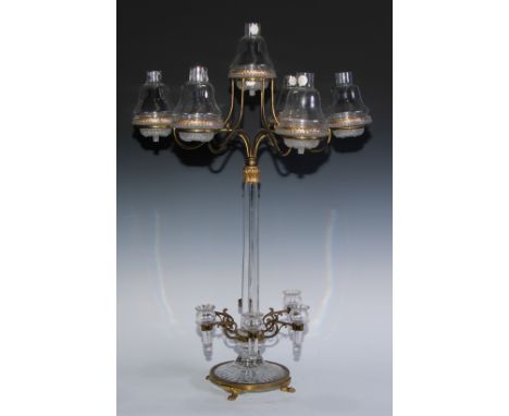 A Clarkes patient Cricklite ormolu mounted clear glass seven light table candelabrum, each bell shaped shade supported on a s