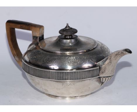 A George III silver lamp shaped teapot, wriggle-work engraved with a band of scrolling leaves, fluted girdle, angular scroll 