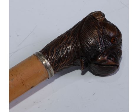 A late 19th century novelty automaton walking stick, the Black Forest pommel carved as the head of a dog, with articulated ja