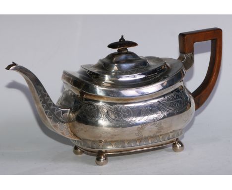 A George III silver boat shaped teapot, bright-cut and wrigglework engraved with birds and scrolling leafy vine, hinged domed