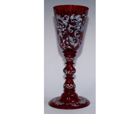A 19th century Bohemian ruby glass wunderkammer pedestal goblet, painted in polychrome enamels with 18th century figures and 