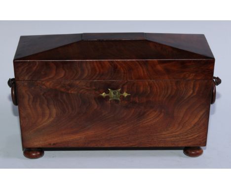 A George V mahogany sarcophagus tea caddy, hinged cover enclosing a bowl aperture flanked by a pair of canisters, ring handle