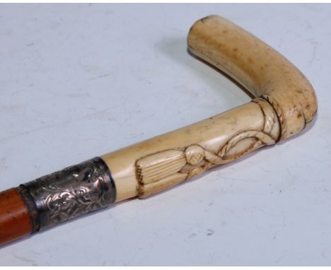 A 19th century walking stick, the L-shaped ivory handle carved with tassles, the silver coloured metal ferrule engraved with 