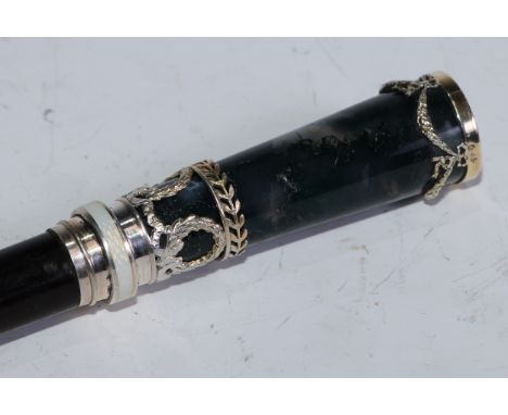 An Austrian Neoclassical Revival moss agate, guilloché enamel and silver-mounted ebony walking stick, the slender tapering se