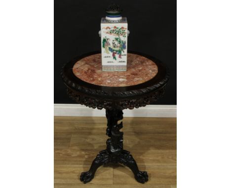 A Chinese hardwood tripod occasional table, circular top with inset soapstone panel, the pillar carved with smiling figures h