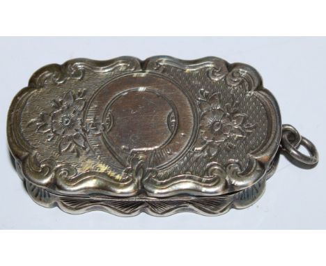 A Victorian silver shaped oval vinaigrette, bright-cut engraved with flowers and scrolling foliage on an engine turned ground