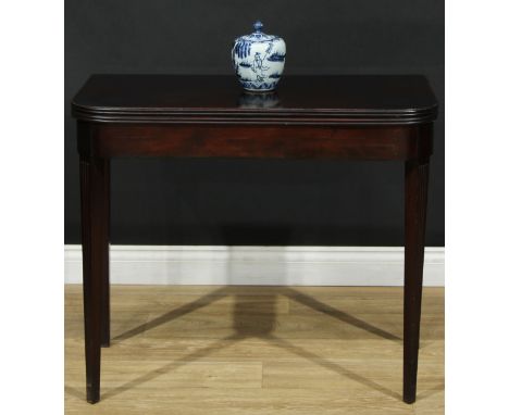 A 19th century mahogany card table, rounded rectangular top with reeded edge enclosing a baize-lined playing surface, tapered