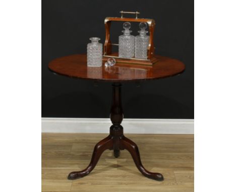 A George III mahogany tripod occasional table, circular tilting top, turned baluster column, cabriole legs, pad feet, 70.5cm 