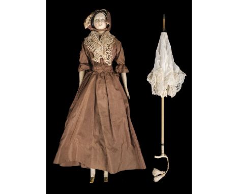 * Doll. A large wooden doll with parasol, circa 1840, painted paper-mâché head with moulded black hair in a bun and blue eyes