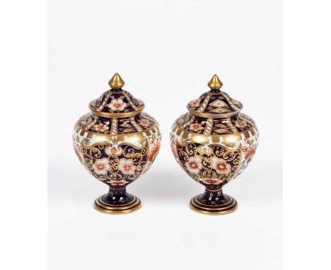 A small pair of Royal Crown Derby Imari lidded vases, shape 1337, pattern 6299, 12cm highNo damage or repair. Light rubbing t