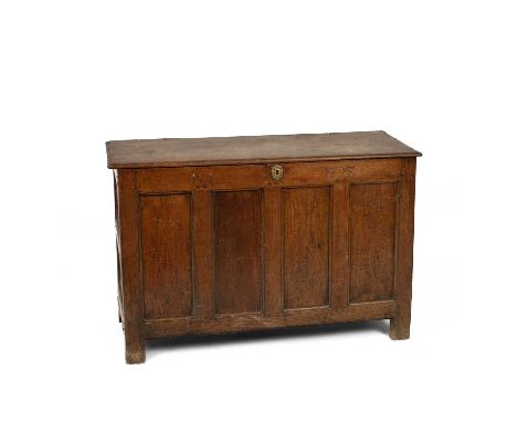 A George II oak chest, with planked top and four-panel front, the frieze initialled P*I and dated 1728, 127.5cm wide, 48.5cm 