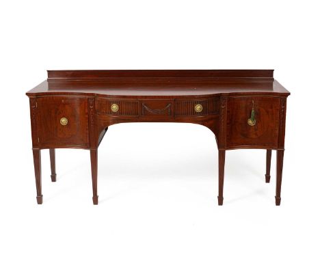 A 19th Century flame mahogany sideboard by Cowtain &amp; Sons Ltd., the serpentine front above a frieze drawer centred by a s