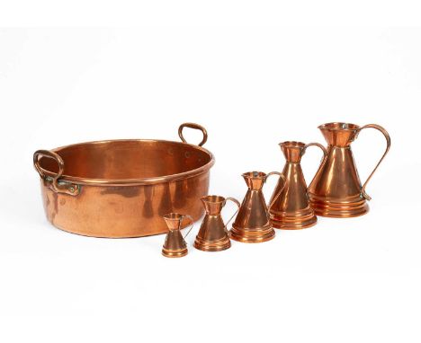 A copper preserving pan, 50cm wide across handles and a set of five copper measures, the largest 24cm high