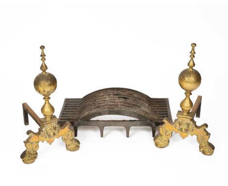 A pair of 17th Century style brass andirons, with globe finials and lion masks to the fronts, 57cm long, together with the ir