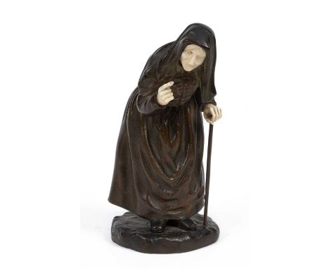 After Paul D’Aire (fl.1890-1910), a bronze and ivory figure in the form of an elderly woman leaning on a cane, inscribed with