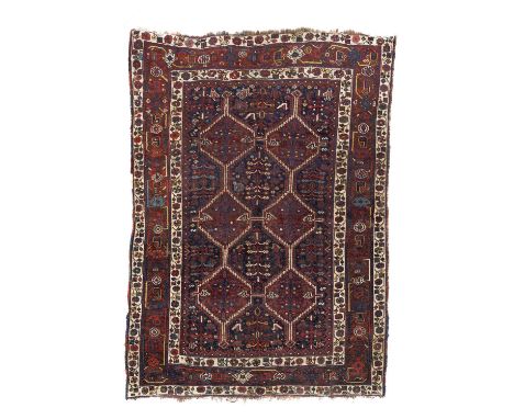 A small Shiraz carpet, South West Persia, the indigo field of flowerheads and ornimorphic motifs, with two deep brick red tri