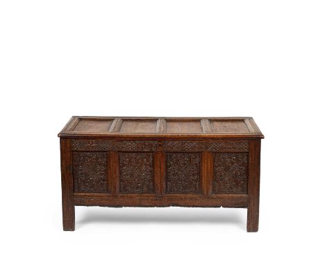 A Charles II oak chest, probably Lakeland, the four panel top within moulded frames above a carved initialled and dated rail 