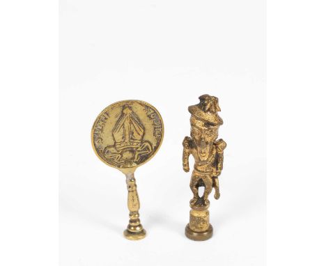 An early Duke of Wellington tobacco stopper, 19th Century and another brass pipe stopper