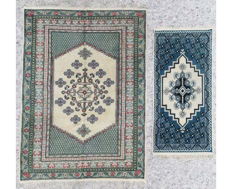 A small Anatolian design carpet, the ivory field centred by an open lozenge medallion, framed by multiple borders, 237cm x 17