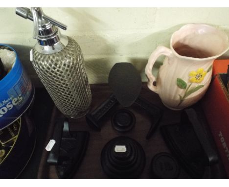 A Tray of Metal Wares to Include Shoe Last, Two Flat Irons, Kitchen Scale Weights, Soda Siphon Etc. 