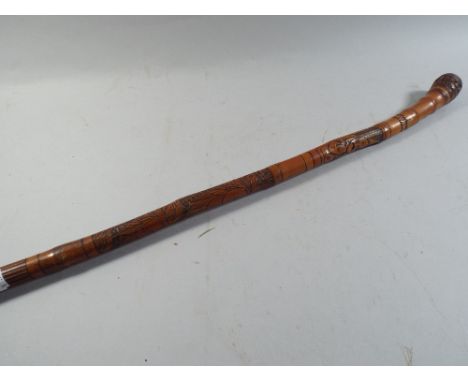 A Carved Oriental Bamboo Walking Stick.