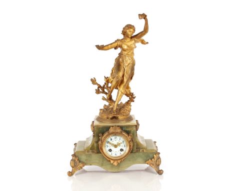 A French gilded spelter and green marble mantel clock, surmounted by a figure of a maiden, circular enamel dial with eight da