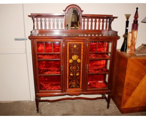 An Art Nouveau mahogany satin wood cross banded and inlaid display cabinet, having raised mirrored back shelf, central marque