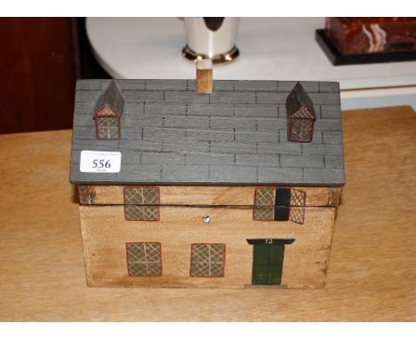 A wooden house shaped tea caddy, 26.5cm wide x 20cm high