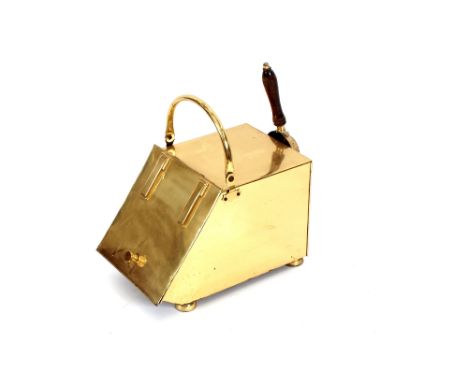 An Art Deco design brass coal scuttle with integral shovel
