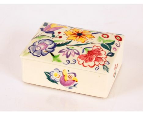 A Poole pottery trinket box and cover with floral decoration