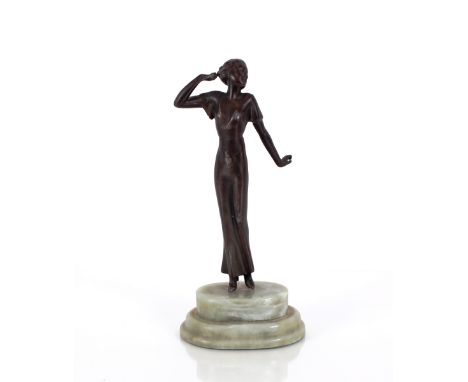 A spelter Art Deco style figurine of a dancing lady on onyx plinth base, 23cm high 