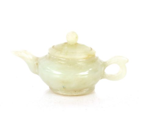 A small jade coloured teapot