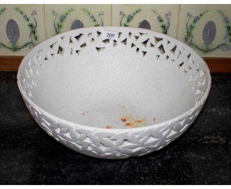 A large white glazed ceramic bowl, having pierced floral decorated sides, 37cm dia. 