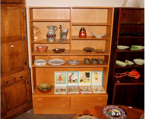 A light oak finish G-plan design wall unit, having adjustable shelves and four drawers below, 139cm wide x 198cm high