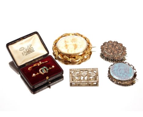 A yellow metal and carved ivory brooch, with revolving panel; two Victorian white and yellow metal brooches; two bar brooches