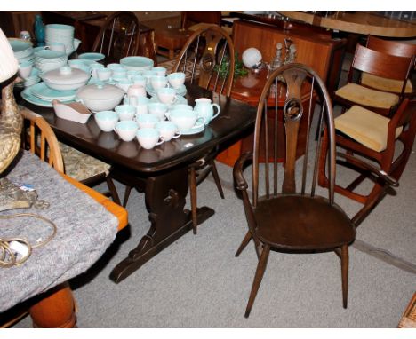 A set of six Ercol stick back dining chairs with swan motifs, (four standards, two elbows)