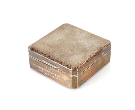 A silver engine turned decorated cigarette box, inscribed "From Commanding Officer HMS Lundy, 3rd September 1947" having wood