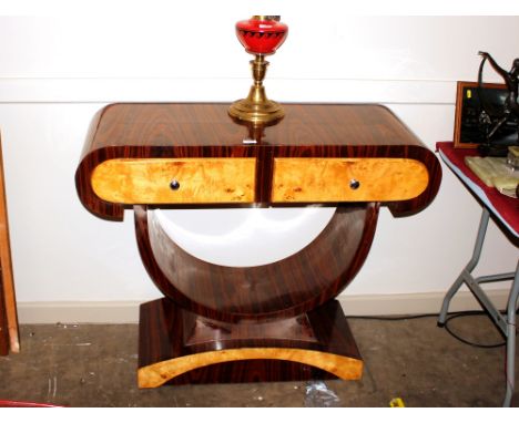 An Art Deco design faux coromandel and satin wood two drawer hall table, raised on a "U" shaped support and plinth, 102cm wid