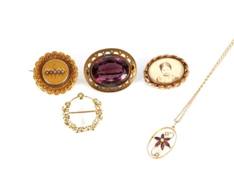 A late Victorian circular yellow metal brooch set peridot and seed pearls; an Art Nouveau style 9ct gold pendant set seed pea