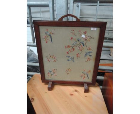 A vintage emroidered firescreen