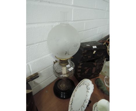 A brass and glass vintage oil lamp, with shade and chimney