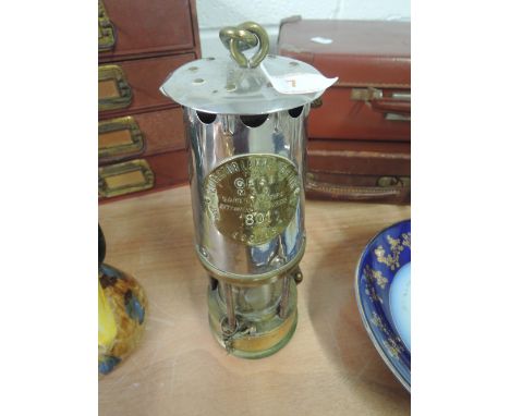 A brass based miners lamp from The Protector Lamp and Lighting Co Ltd, Eccles stamped 1801