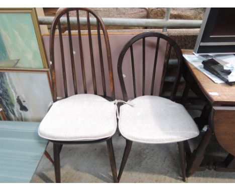 Two dark stained Ercol hoop and stick back dining chairs