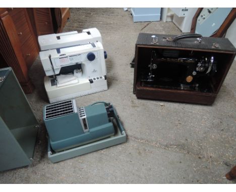 Two vintage sewing machines and a projector