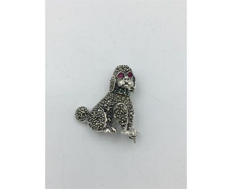 A silver Marcasite Poodle Brooch with ruby eyes